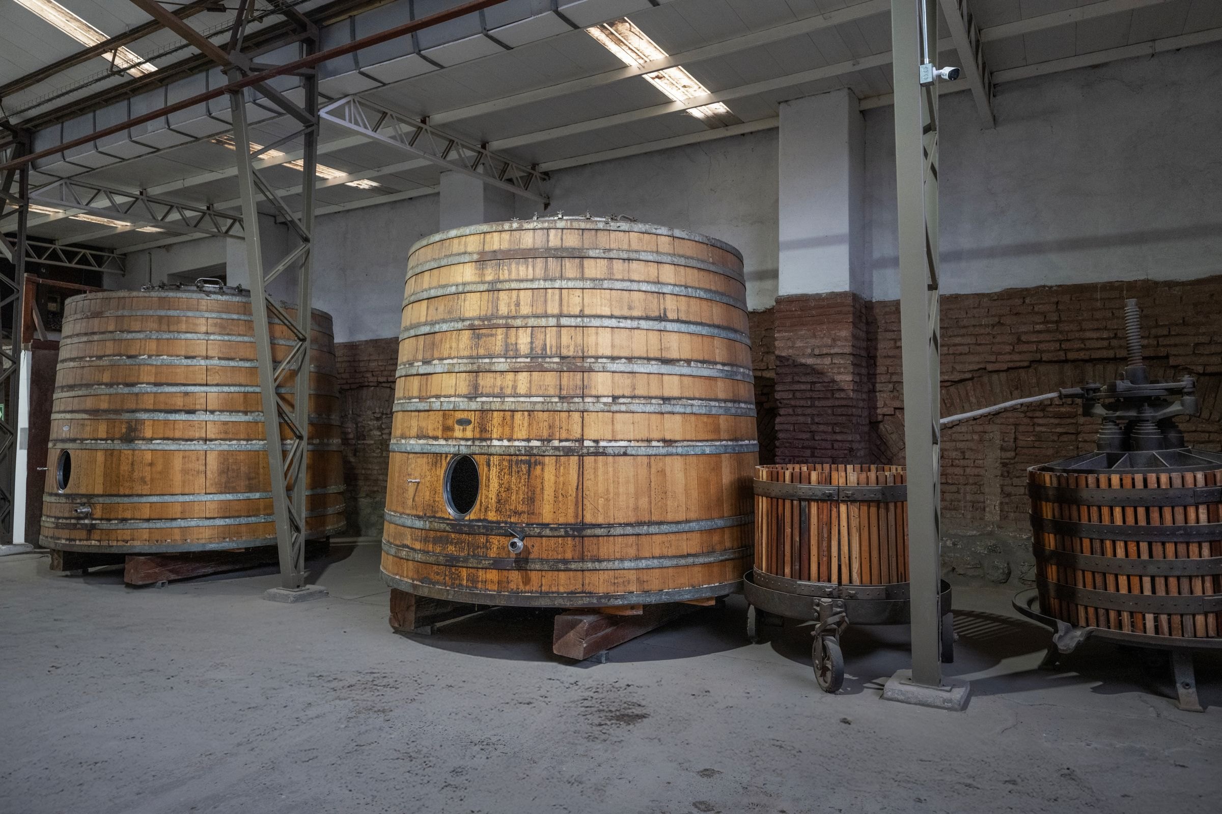 Wooden fermentation barrels in a winery