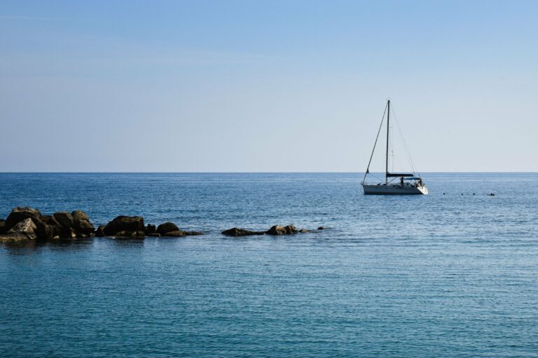 A yacht sailing on a clear blue sea